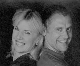 Iris Loesel and Andreas Kurz smiling, standing back-to-back